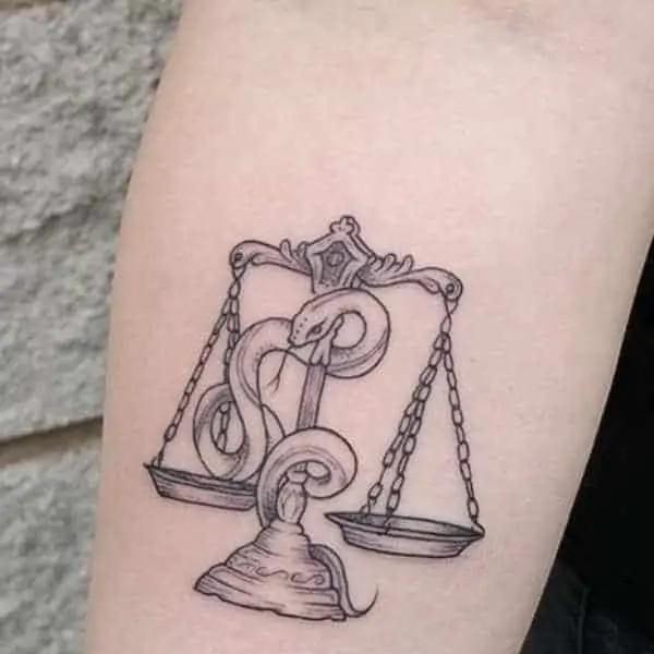 Libra scale with snake tattoo