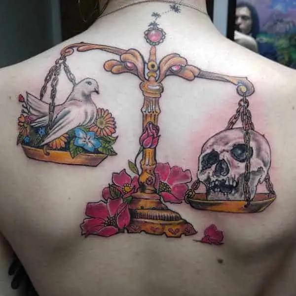 Libra scales with dove and skull back tattoo