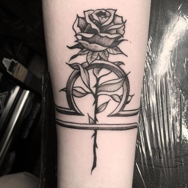Libra sign and rose forearm tattoo