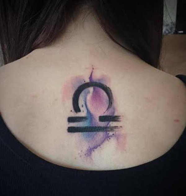 Libra sign on watercolor backdrop back tattoo
