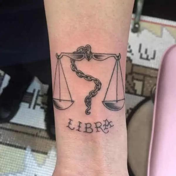 Libra with chain arm tattoo