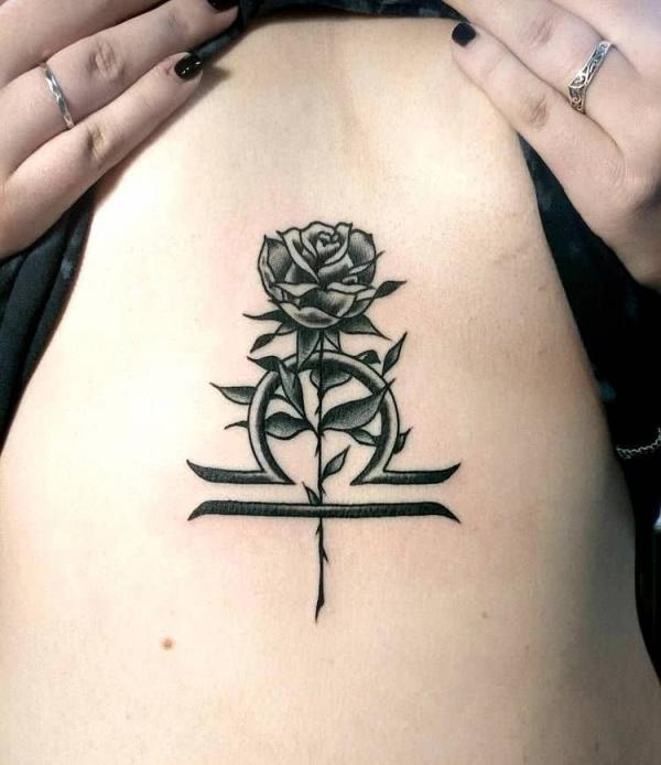 Libra with rose sternum tattoo
