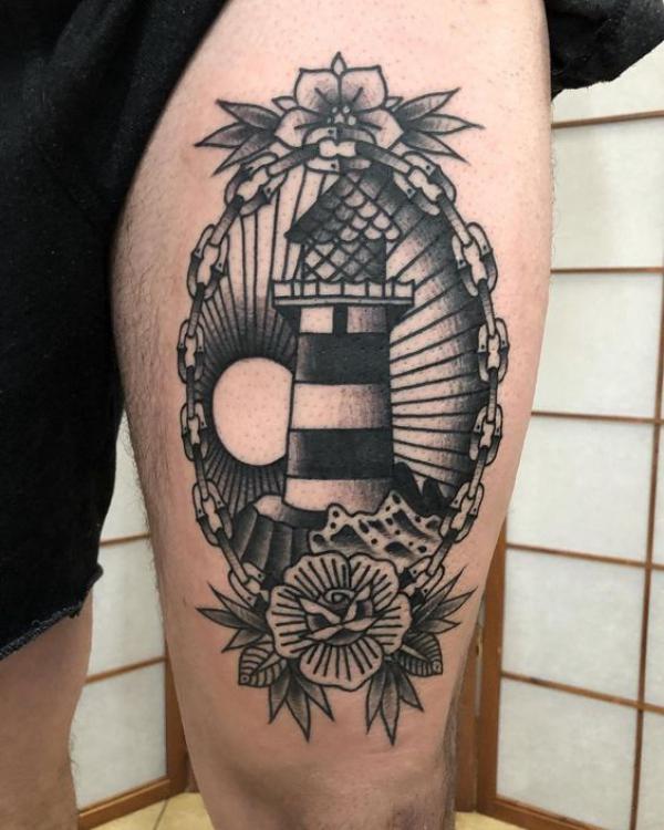 Lighthouse above knee tattoo
