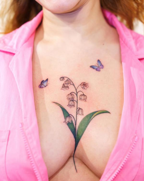 Lily of the valley with butterfly sternum tattoo