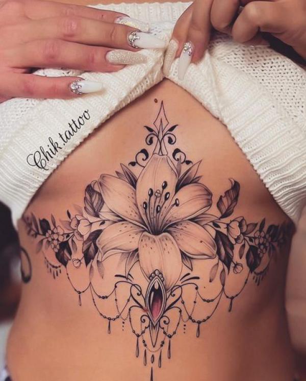 Lily with diamond sternum tattoo