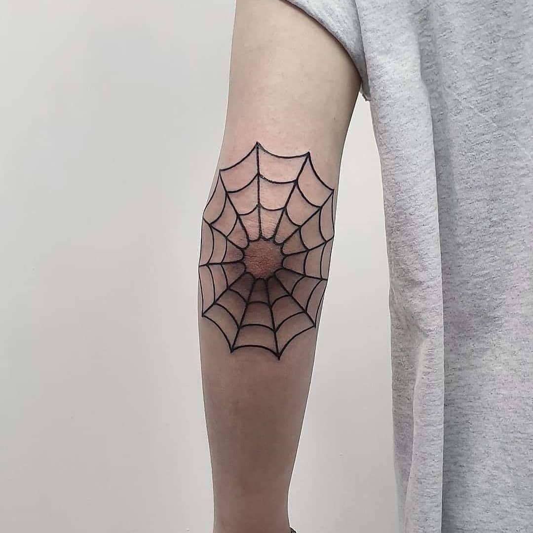 Linework spiderweb tattoo on elbow