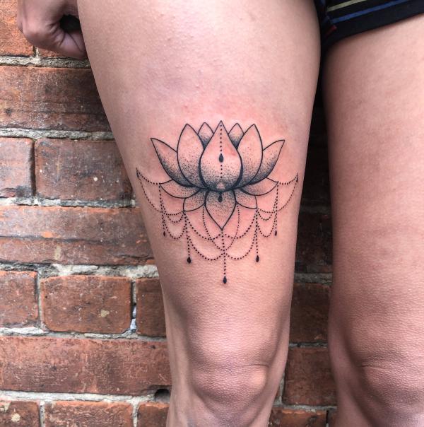 Lotus above knee tattoo