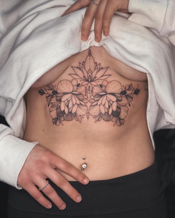 Lotus outline and peony sternum tattoo