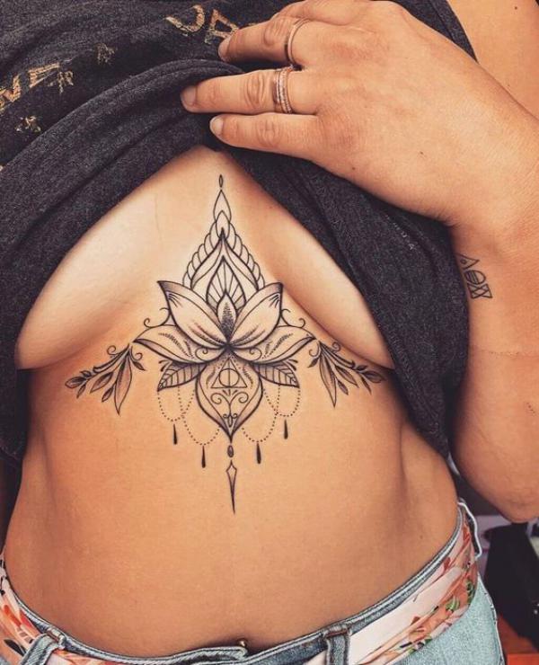 Lotus with pendant sternum tattoo