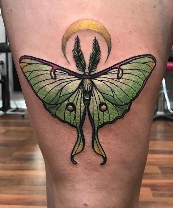 Lunar moth and crescent moon above knee tattoo