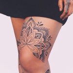 Mandala above knee tattoo black and grey
