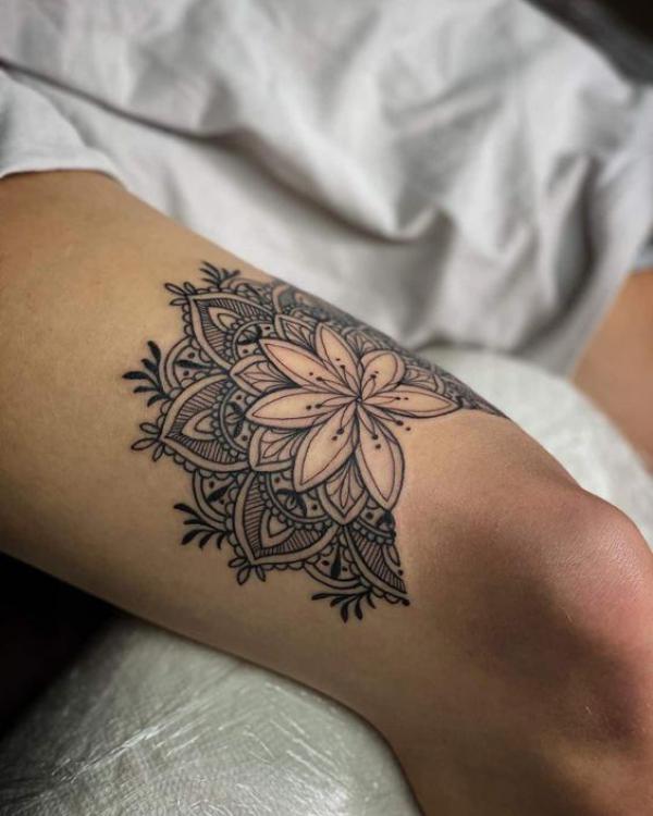 Mandala flower above knee tattoo