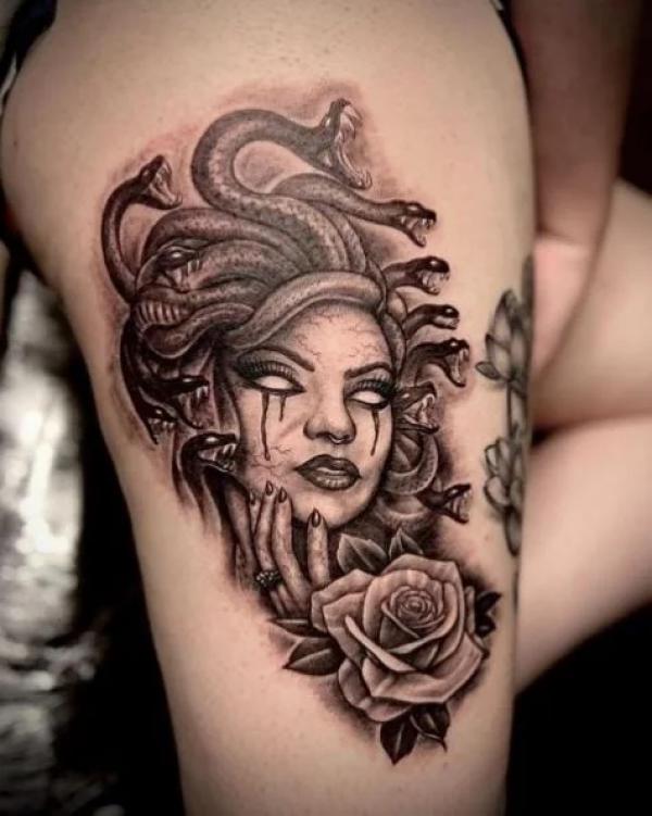 Medusa and rose thigh tattoo