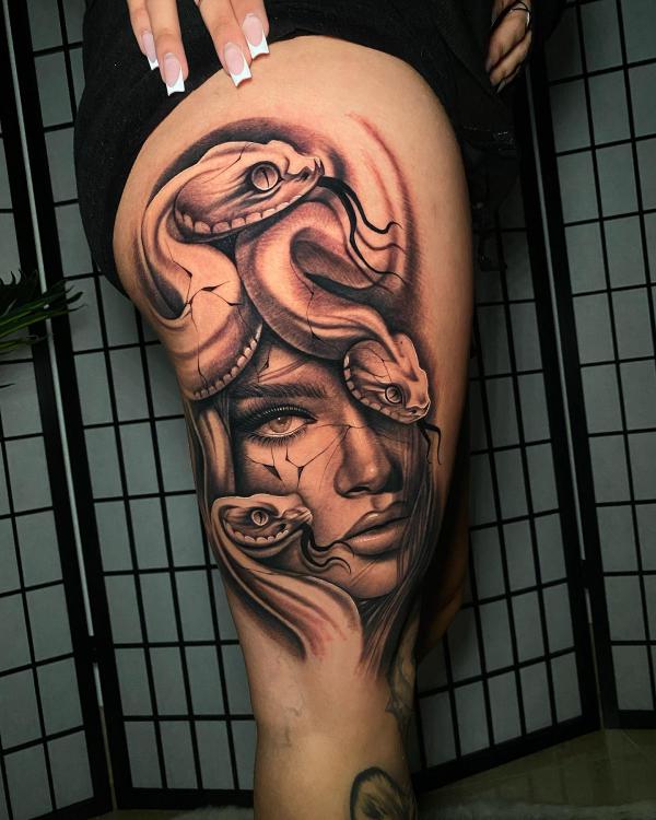 Medusa and snake side thigh tattoo