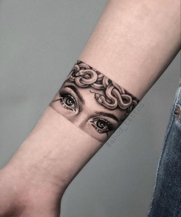 Medusa eye and snake armband tattoo