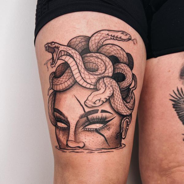 Medusa eye and snake thigh tattoo