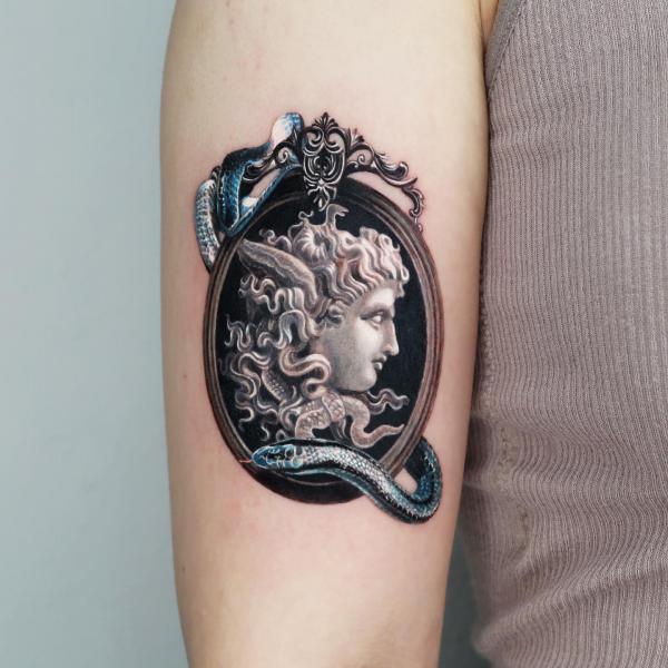 Medusa frame with snake tattoo