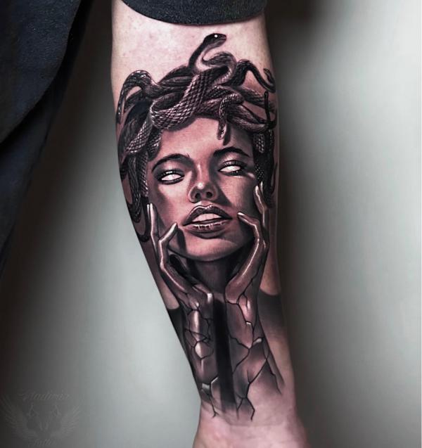 Medusa holding her head with both hands forearm tattoo