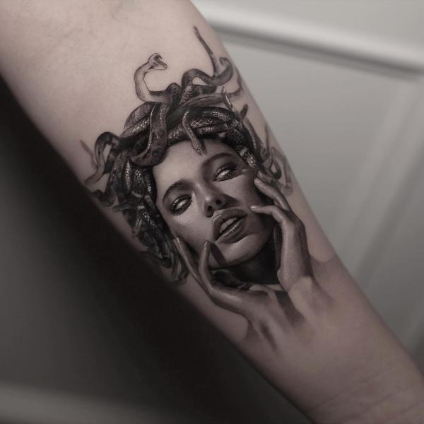 Medusa holding her head with both hands tattoo