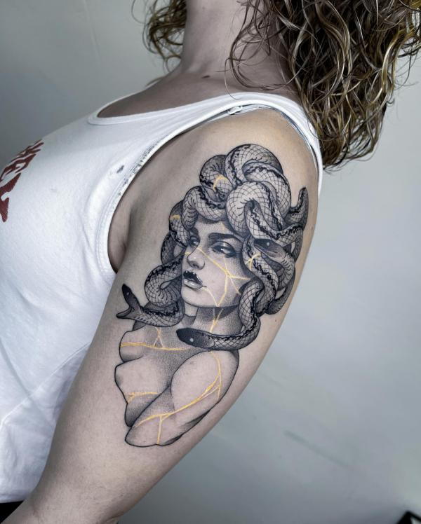 Medusa upper arm tattoo black and grey