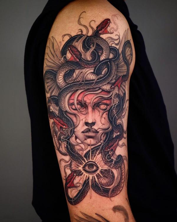 Medusa with eye tattoo on upper arm