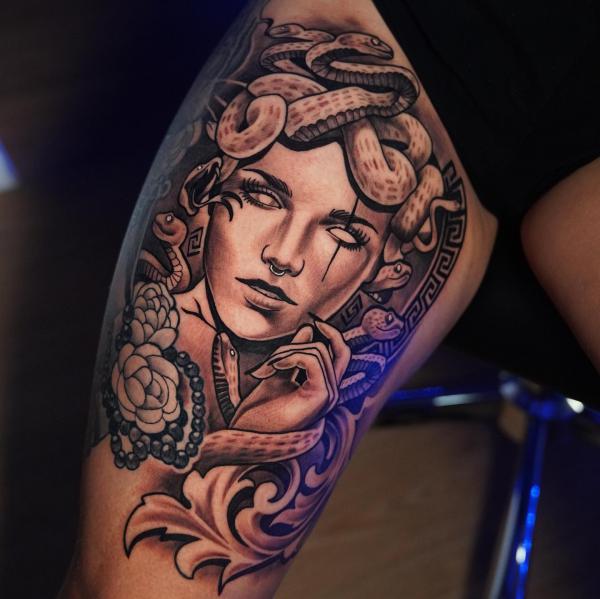 Medusa with peony and Greek key thigh tattoo