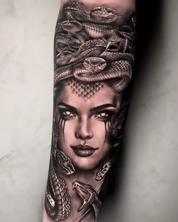 Medusa with silver skin snake forearm tattoo