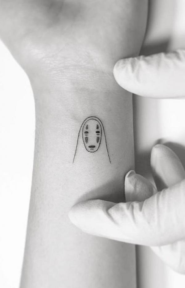 Minimalist No Face wrist tattoo
