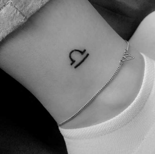 Minimalist libra sign ankle tattoo