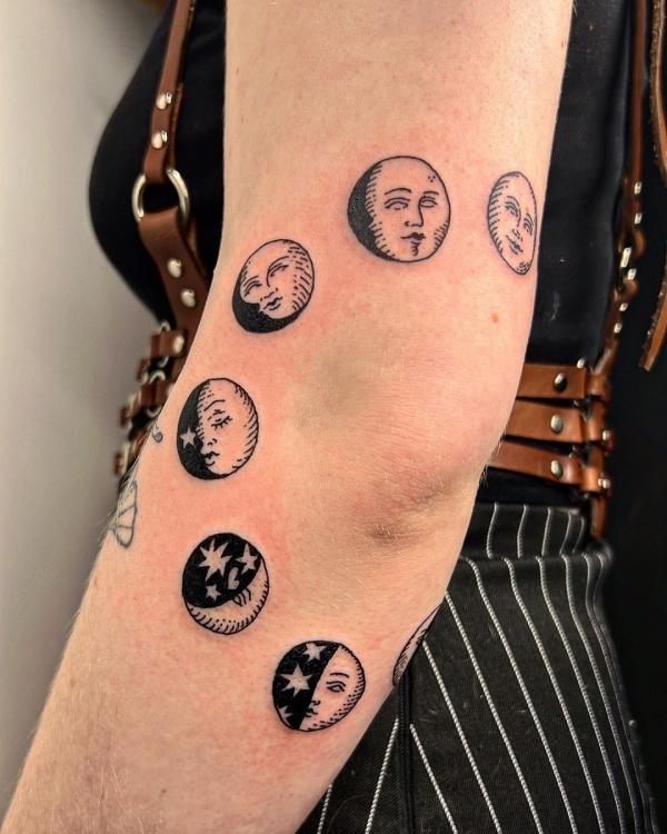 Moon phase elbow tattoo