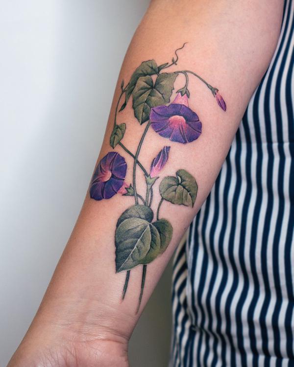 Morning glory upper arm tattoo