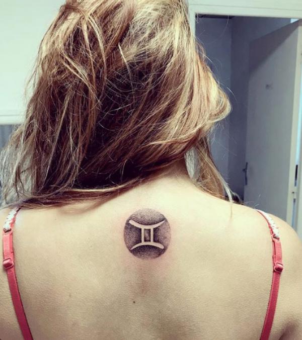 Negative space Gemini sign tattoo
