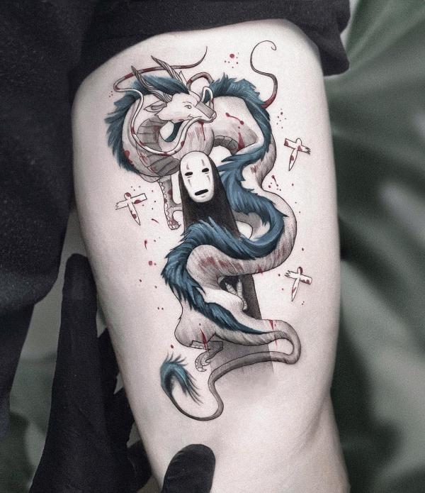 No Face and dragon upper arm tattoo