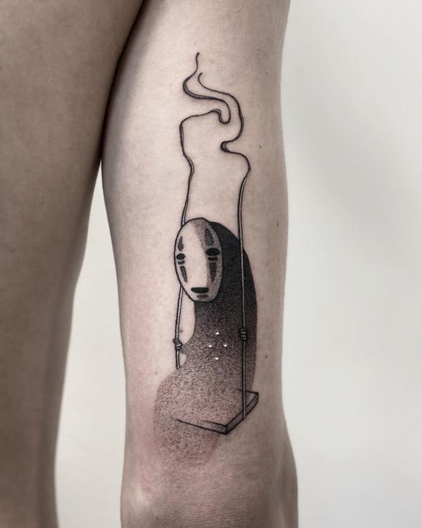 No Face back of arm tattoo