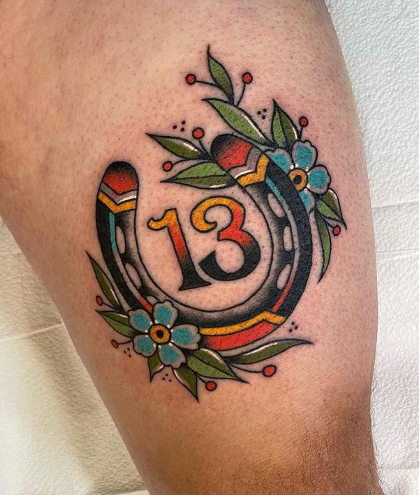 Number 13 and horseshoe with flower tattoo traditional