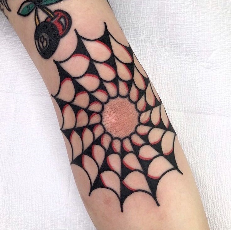 Old school spider web tattoo on elbow