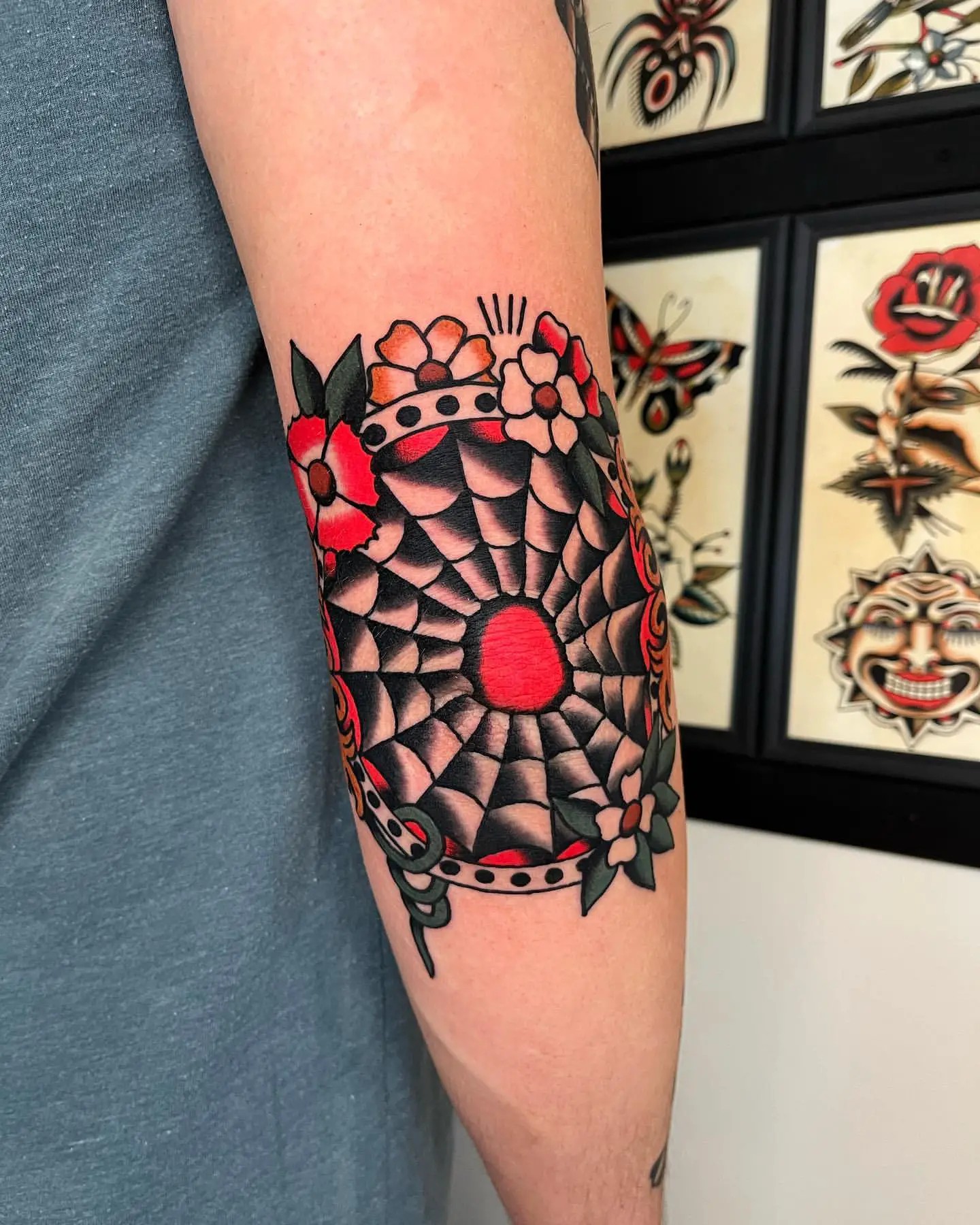 Old school spiderweb with flower elbow tattoo