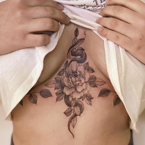 Peony and snake sternum tattoo