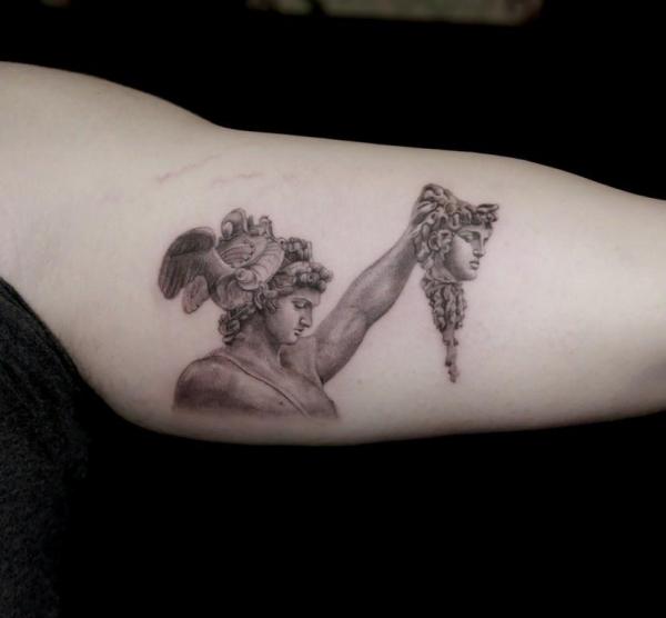 Perseus holding Medusa head arm tattoo