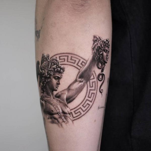 Perseus holding Medusa head forearm tattoo