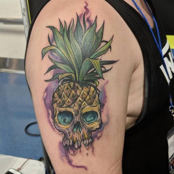 Pineapple Skull upper arm tattoo