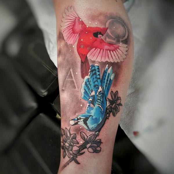 Playful blue jay and cardinal tattoo