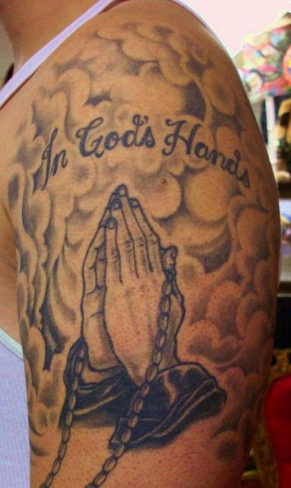 Praying hands with clouds tattoo