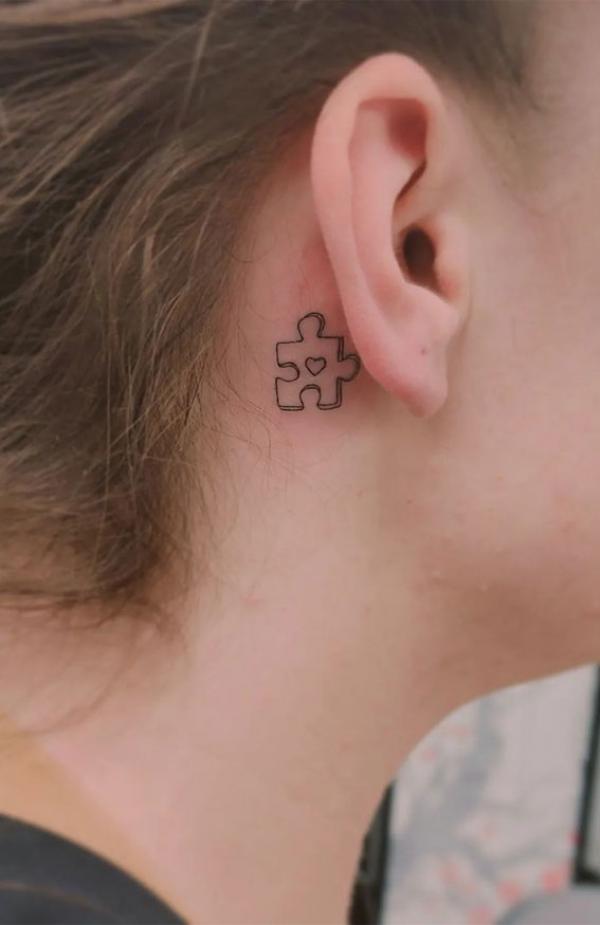 Puzzle outline tattoo behind ear