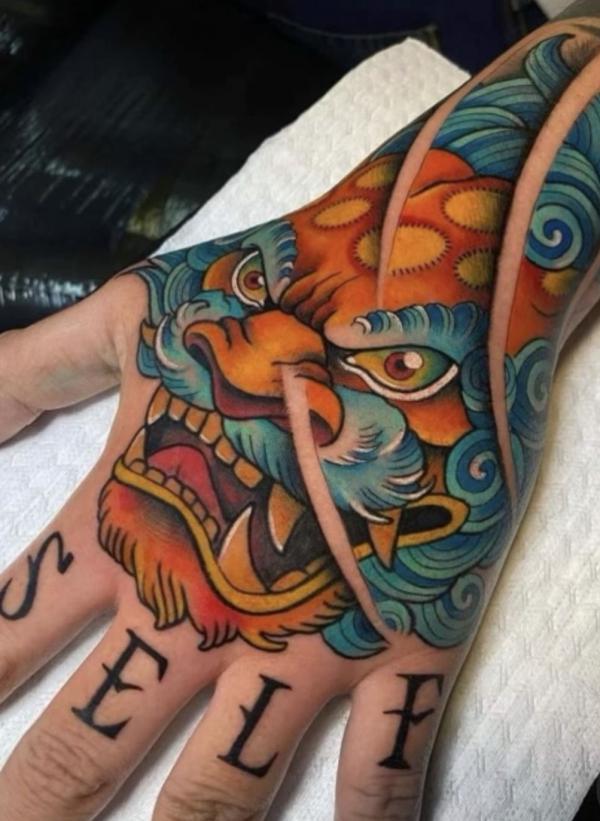 Red and blue foodog hand tattoo