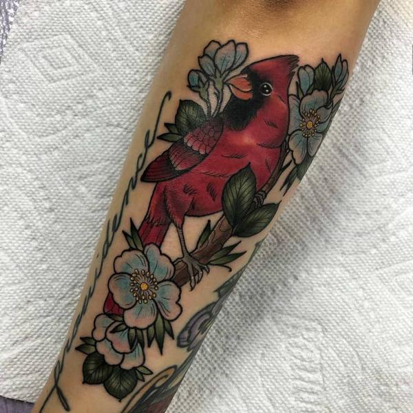 Red cardinal in dogwood flower tattoo forearm