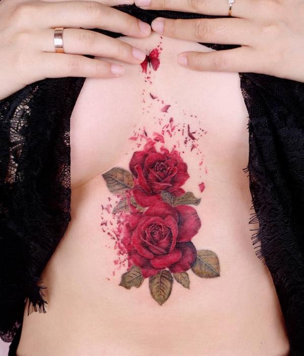 Red roses sternum tattoo