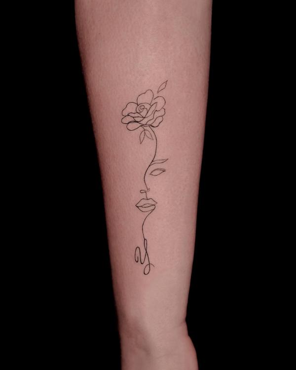 Rose and female face outline tattoo