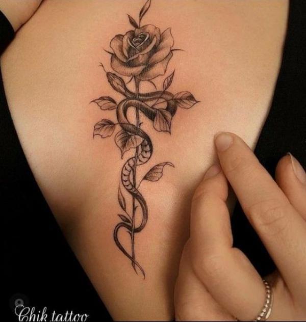 Rose and snake sternum tattoo