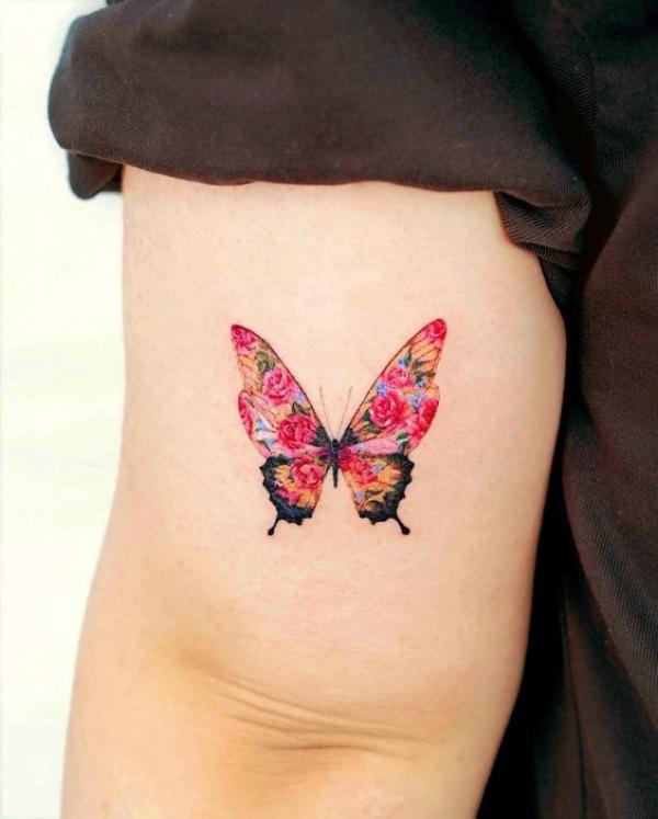 Rose butterfly tattoo above elbow